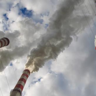 Smokestacks against a cloudy sky.